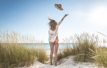 Fototapeta premium Young people sharing happy and love mood on the beach. Couple in love get in connection with tuscan nature