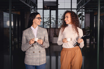 Coworkers talking during coffee break in office