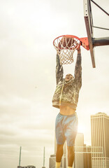 Huge slam dunk. Young american player playing basketball at the court in New york city