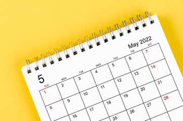 May 2022 desk calendar on yellow background.