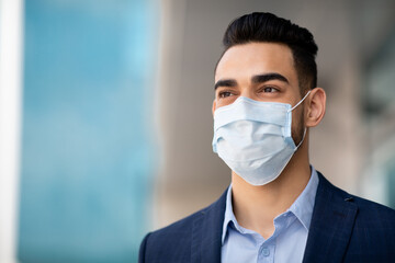 Middle-eastern guy businessman in medical face mask