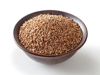 Uncooked roasted buckwheat in ceramic bowl isolated on white background with clipping path