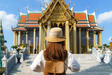 Asian woman traveler at Wat phra keaw is Buddhist temple in Bangkok, Thailand. It is one of...