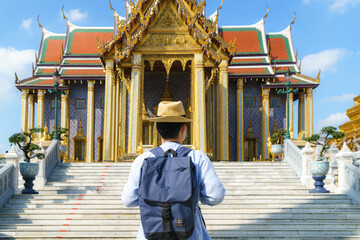 Asian man traveler at Wat phra keaw is Buddhist temple in Bangkok, Thailand. It is one of Bangkok's...