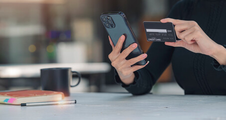 Asian woman holding and presenting the credit card for online shopping, technology money wallet and online payment concept, credit card mockup.
