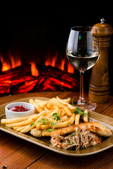 Fried chicken with french fries and salad, greens - junk food and unhealthy food. Fast food set fried chicken and french fries
