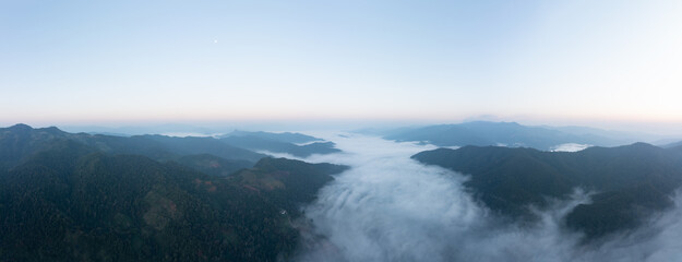 beautiful amazing landscape aerial view Mountain fog in the valley at morning with blue sky background