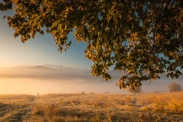 Colorful autumn near the Tatras. Peaks and hills bathed in the light of the setting sun.