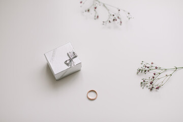 siver box with engagement ring on white background