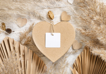 Heart shaped Valentines present with square blank gift tag, pampas grass and hearts, boho Mockup