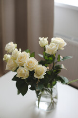 White rose bouquet in a cozy home interior. Floral spring background