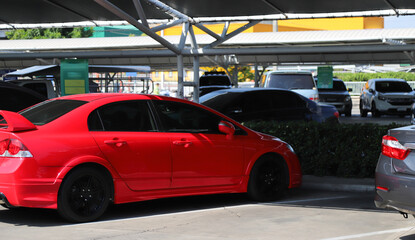 Fototapeta na wymiar Closeup of rear side of red sedan car parking in parking area.