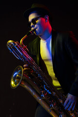 Japanese Musician Saxophonist Holds a Soprano Straight Saxophone in his Hand and Poses for Camera...