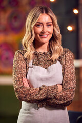 Portrait Of Smiling Female Server Working Night Shift In Bar Restaurant Or Club