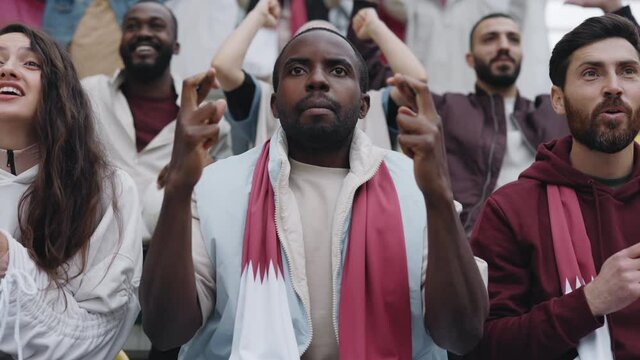 Excited african american man cheering during soccer game