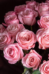Pink roses on brown background close up. Bouquet for woman