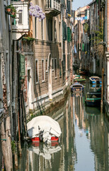 Fototapeta na wymiar narrow canal in venice with parking boats