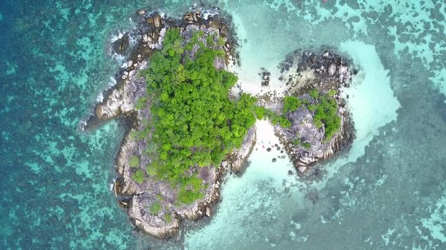 Stunning summer landscape. Aerial view of turquoise Andaman sea with reef and small island at Koh Lipe or Lipe island, Satun, Southern Thailand. 4K drone video