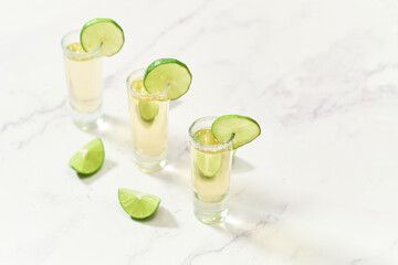 Three traditional tequila shots with lime and salt. Mexican tradition.