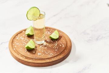 Tequila tequila shot on wooden board. Mexican alcoholic drink.