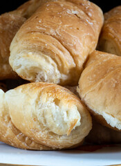 Sweet croissants in a plate on the table