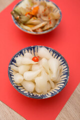 Amazing of Vietnamese food for Tet holiday in spring, it is traditional food on lunar new year:  pickled small leeks,carrot on red background 