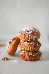Cupcakes tower. Delicious carrot cupcakes with walnut, raisins and sugar powder.  Brown. Please for text. Sweet food. Food for celebration. Autumn baking