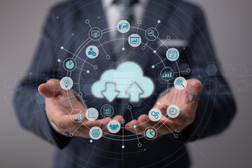 Chart and graph icons on a digital screen interface and a businessman in the background, big data analytics and business intelligence idea.