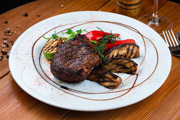 beef steak with grilled vegetables on a plate