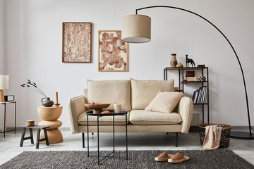 Creative composition of modern living room interior with mock up poster frame, beige sofa, side...