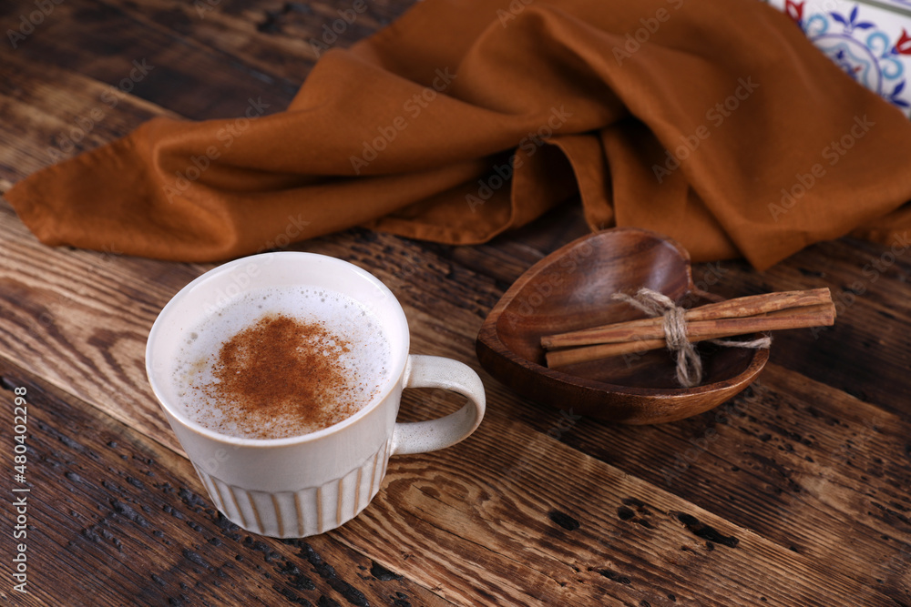 Sticker coffee with cinnamon on a wooden table