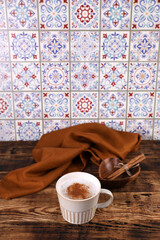 Coffee with cinnamon on a wooden table