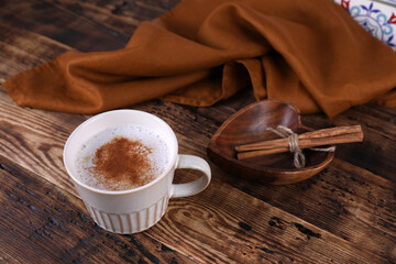 Coffee with cinnamon on a wooden table