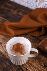 Coffee with cinnamon on a wooden table