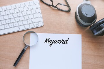 Magnifying glass on the white paper with KEYWORD letterings