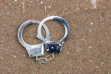 handcuffs lie on the old concrete floor