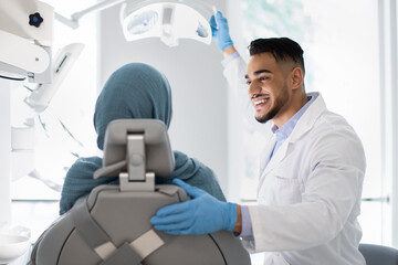 Young Arab Dentist Doctor Having Check Up With Islamic Female Patient