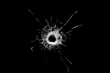 Texture of broken glass. Hole from a ball on a black background.