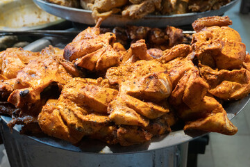 Spicy roasted tandoori butter chicken , prepared for sale at evening as street food in Old Delhi market. It is famous for spicy Indian non vegetarian street foods. It is famous tourist spot.