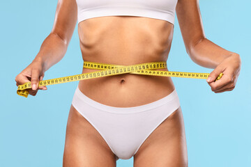 Closeup of Unrecognizable Woman Measuring Waist With Tape