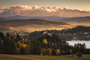 A view of the Niedzica castle against the backdrop of the Tatra Mountains, surrounded by an autumn...