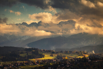 Tatra Mountains seen on a cloudy day. The shining light between the clouds creates an interesting atmosphere in the photo.