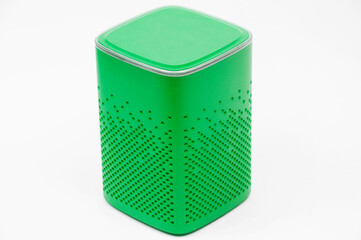 portable green speaker on white background.the concept of listening to music. wireless audio...