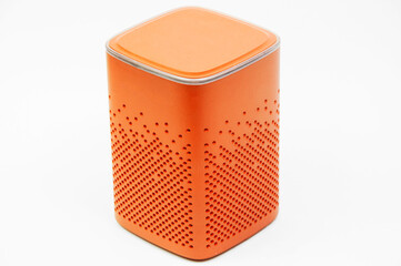 portable orange speaker on white background.the concept of listening to music. wireless audio...