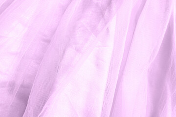 Beautiful nude violet tulle with shiny sequins background. Draped background of pink powdery fabric, texture. Copy space. Close up