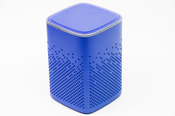 portable blue speaker on white background. The concept of listening to music. wireless audio playback device. color subwoofer