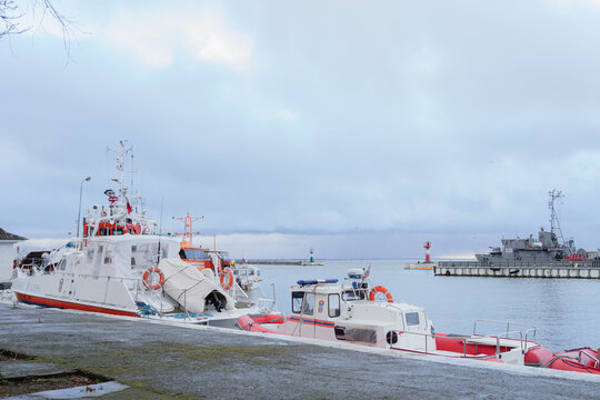 an industrial port with anchored tugs and crane equipment. Baltiysk city 2021 November 21