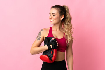 Young Brazilian woman isolated on pink background with boxing gloves