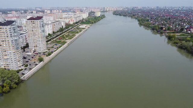 New residential buildings on the Kubanskaya embankment. The Kuban River. Flight over the city. Beautiful view of the river. Drone.