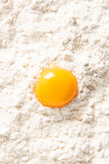 View from above of egg yolk on flour.